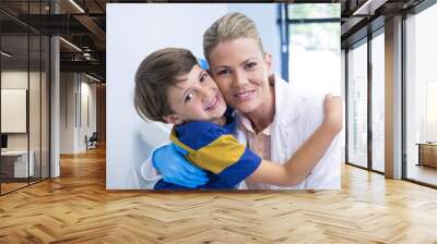 Portrait of smiling dentist with boy Wall mural