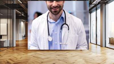 Portrait of smiling male doctor holding clipboard Wall mural