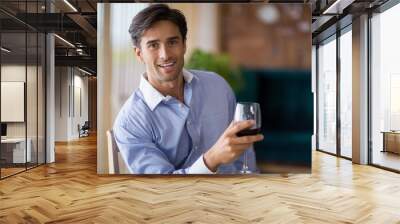 Portrait of smiling man holding glass of red wine Wall mural