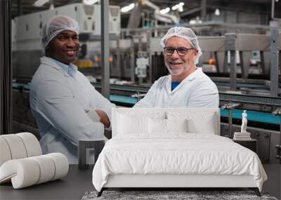 Portrait of two factory engineers standing with arms crossed Wall mural