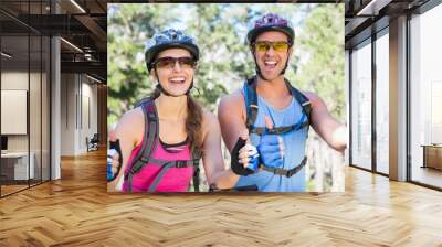 Portrait of young couple showing thumbs up sign Wall mural