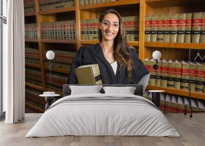 Pretty lawyer looking at camera in the law library Wall mural