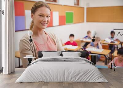 pretty teacher smiling at camera at top of classroom Wall mural