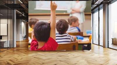 Pupil raising hand during geography lesson in classrorm Wall mural