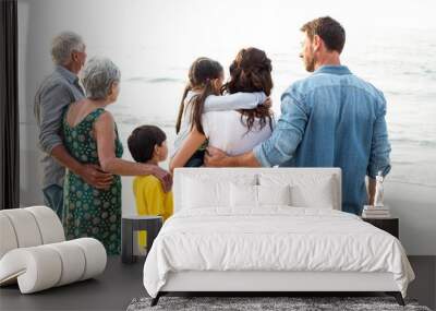 Rear view of a happy family posing at the beach Wall mural