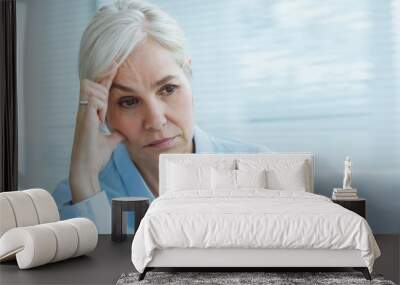 Sad senior woman at home Wall mural