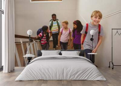 School kids walking up stairs in school Wall mural