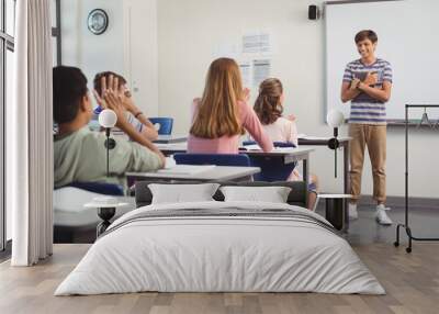 Schoolboy giving presentation in classroom Wall mural