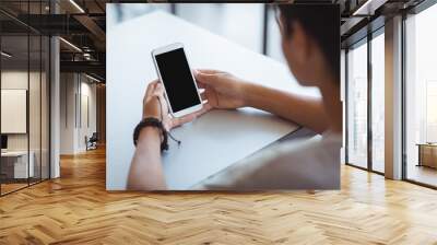 Schoolboy using mobile phone in classroom Wall mural