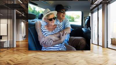 Senior couple enjoying on car back seat Wall mural