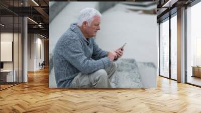 Senior man using mobile phone Wall mural