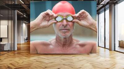 Shirtless male swimmer wearing swimming goggles Wall mural