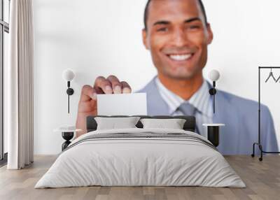 Smiling attractive businessman holding a white card Wall mural