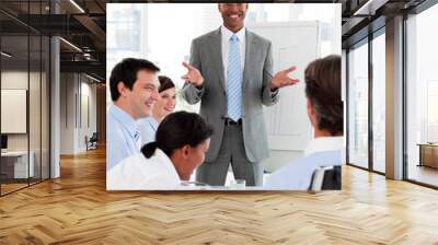 Smiling businessman doing a presentation to his colleagues Wall mural