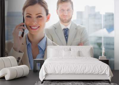 Smiling businesswoman having phone conversation Wall mural