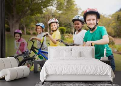 Smiling children posing with bikes Wall mural