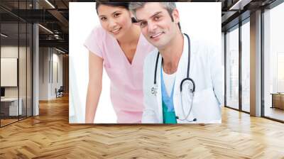 Smiling doctor and nurse working at computer Wall mural