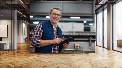 Smiling factory worker using digital tablet in the factory Wall mural