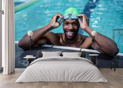 smiling fit african american man in the swimming pool Wall mural