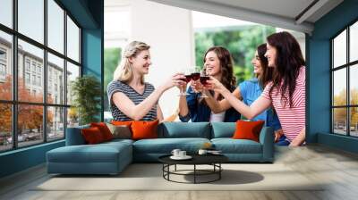 Smiling friends toasting red wine glasses  Wall mural