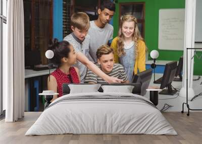 Smiling students studying in computer classroom Wall mural