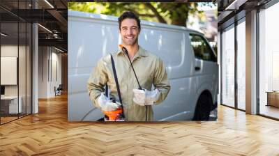 Smiling worker with pesticide sprayer Wall mural