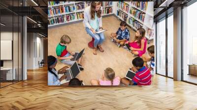 teacher giving lesson to her students with technology Wall mural