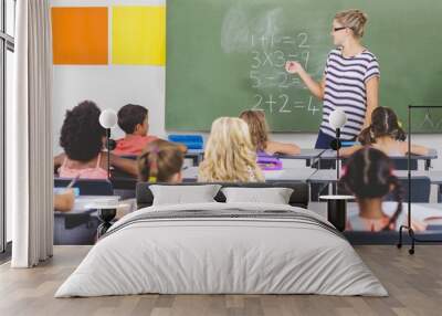 Teacher teaching mathematics to school kids in classroom Wall mural