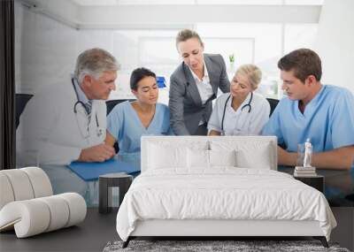 Team of doctors and businesswoman having a meeting Wall mural