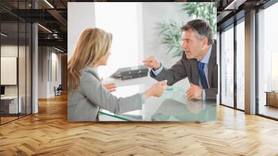 Two angry co workers arguing in an office Wall mural