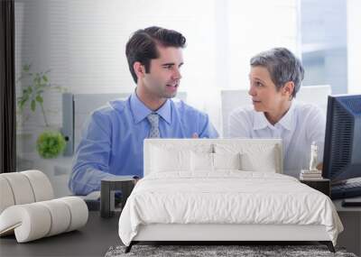 Two business people looking at a paper while working on folder  Wall mural