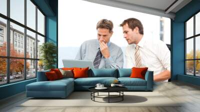 two concentrated businessmen working together on a laptop Wall mural