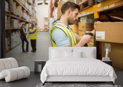 Warehouse worker scanning barcode on box Wall mural