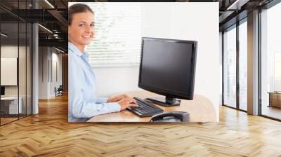 woman in office looking while typing Wall mural