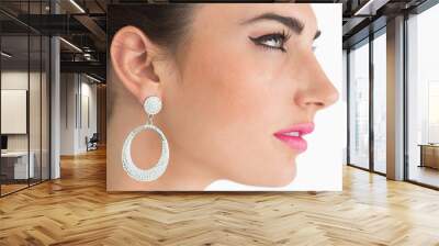 Woman wearing earrings in sixties makeup Wall mural