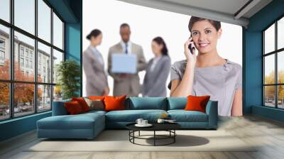 Woman with her head tilted slightly smiling on the phone and co- Wall mural