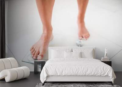 Womans feet going on weighting scale Wall mural