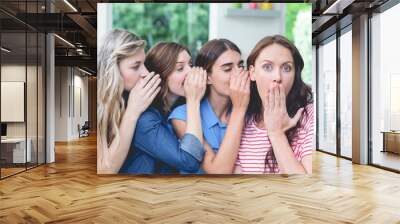 Women in a row whispering secrets in their friends ears Wall mural