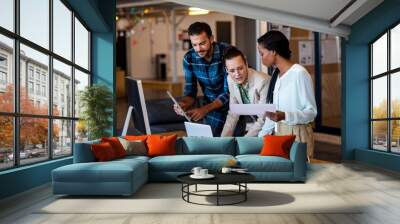 young multi-ethnic business people working at computer desk Wall mural