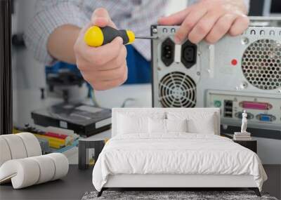 Young technician working on broken computer Wall mural