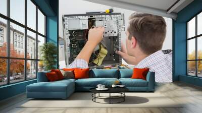 Young technician working on broken computer Wall mural