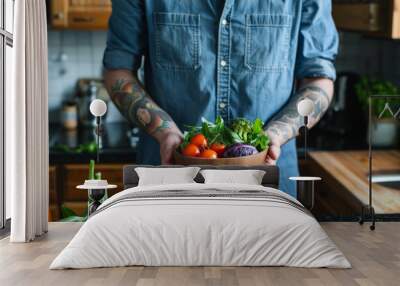 Tattoed man holding bowl with vegetables Wall mural