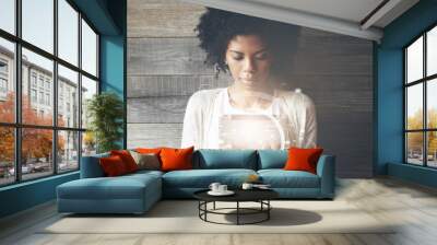 Futuristic technology and communication concept. Smiling pretty black girl with Afro hairstyle using digital tablet, checking email or typing a message. Visual effects. Worldwide connection interface Wall mural