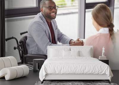 handsome cheerful black male invalid in wheelchair involved in charity, meets with female investor,  Wall mural