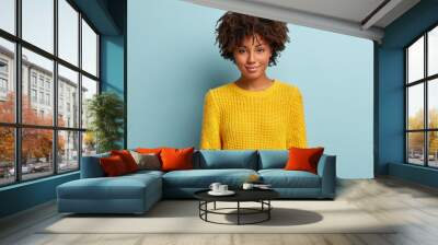 headshot of black curly woman has gentle smile, appealing look, healthy dark skin, afro hairstyle, w Wall mural