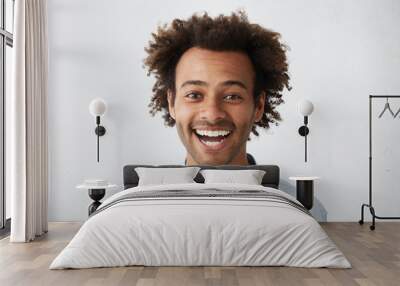 Positive human facial expressions. Stuido portrait of happy cheerful young African American customer or businessman with Afro hairstyle looking at camera in excitement, happy with good news Wall mural