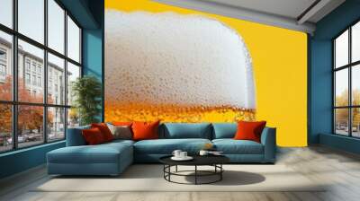 Close up of Beer with Foam and Bubbles on Yellow Background Wall mural