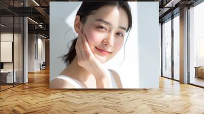 Portrait of a serene Asian woman with a subtle smile and clear skin Wall mural