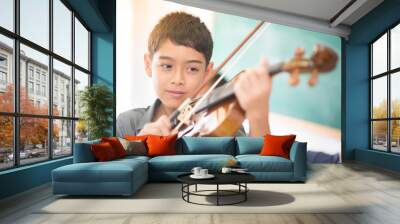 Little boys play and practice violin in the music class room Wall mural