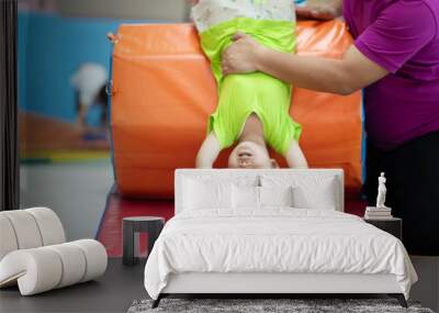 Little toddler boy working out at the indoor gym excercise Wall mural